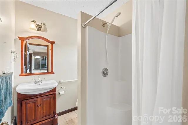 a view of an empty room with a window and a fireplace