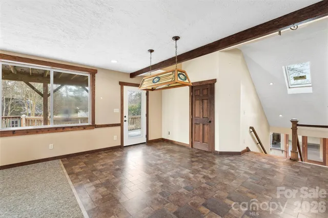 an empty room with closet and a ceiling fan