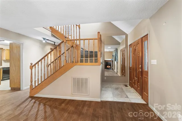 a kitchen with stainless steel appliances granite countertop a refrigerator a sink and a stove