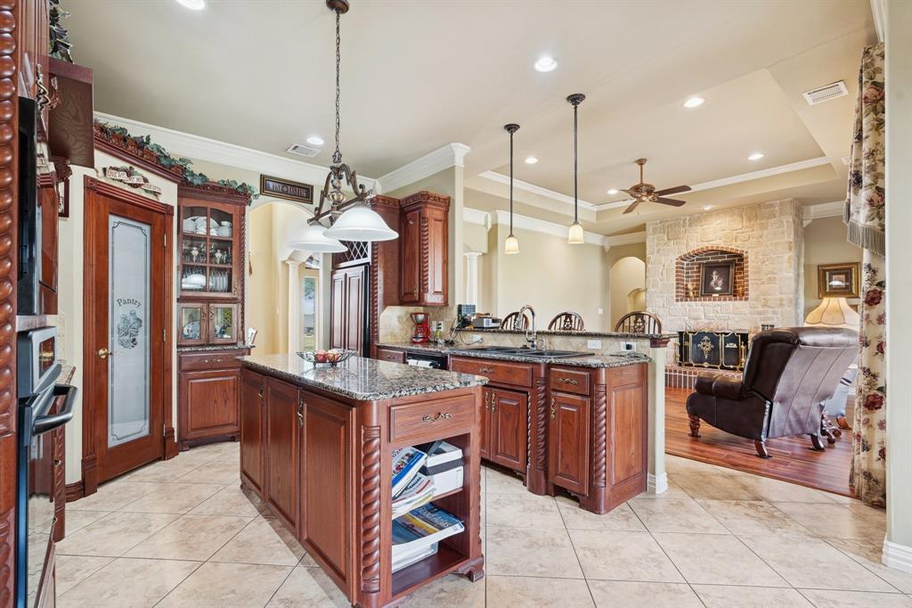 2308 Kella Court Haslet, TX 76052 - Photo 13 of 40 a open kitchen with granite countertop a stove and a sink