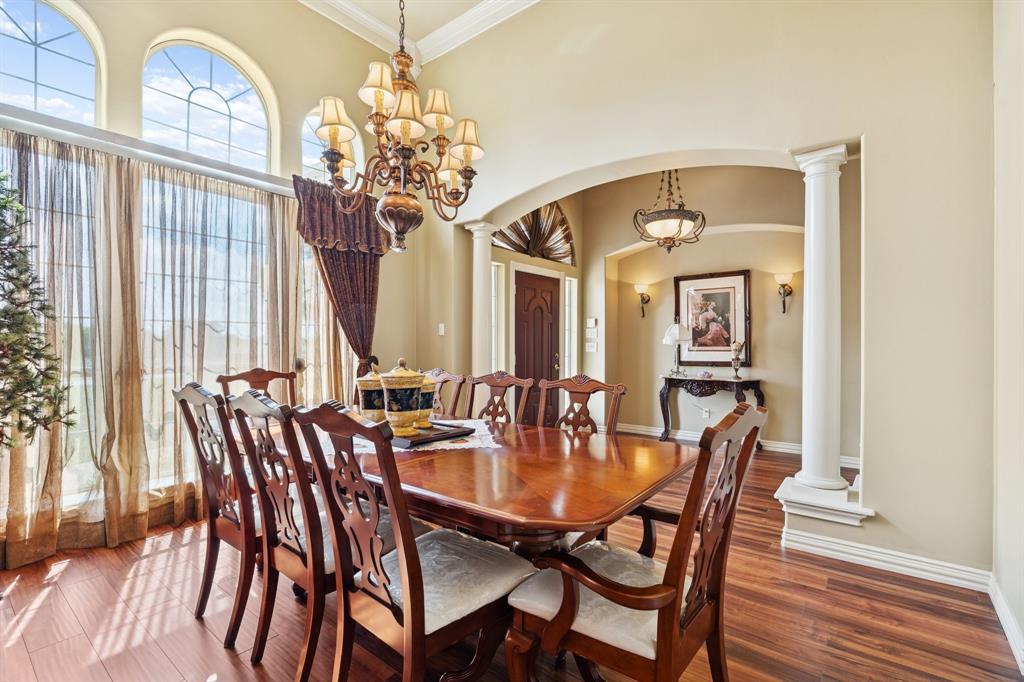 2308 Kella Court Haslet, TX 76052 - Photo 8 of 40 a dining room with furniture a chandelier and wooden floor