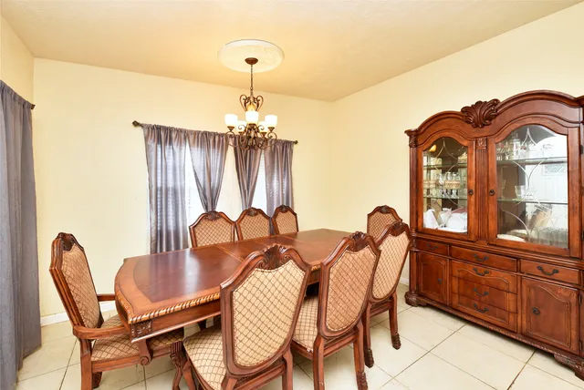 a view of a dining room with furniture and chandelier