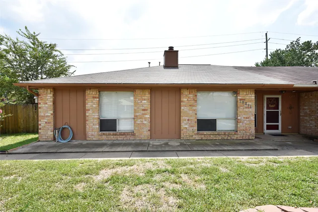 a view of front door of house with car parked