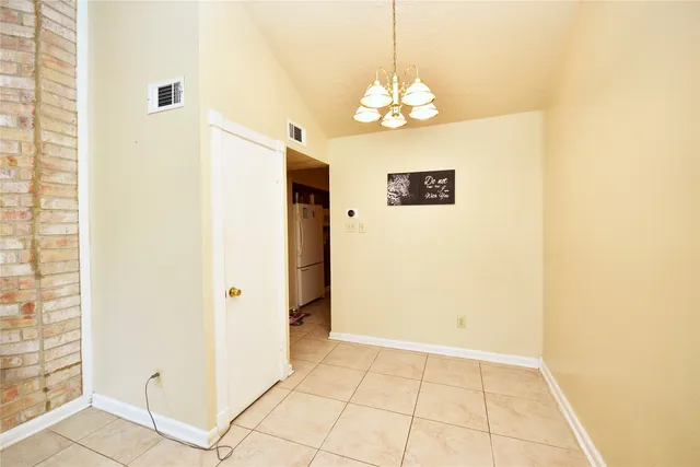 a view of a hallway with a chandelier