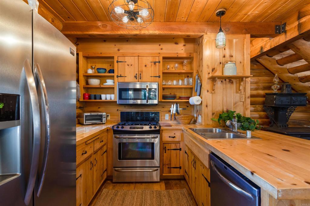 33480 Bailey Meadow Road Palomar Mountain, CA 92060 - Photo 18 of 51 a kitchen with stainless steel appliances granite countertop a refrigerator and a sink