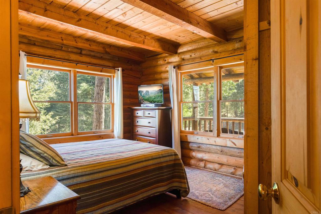 33480 Bailey Meadow Road Palomar Mountain, CA 92060 - Photo 21 of 51 a bedroom with a bed and wooden floor