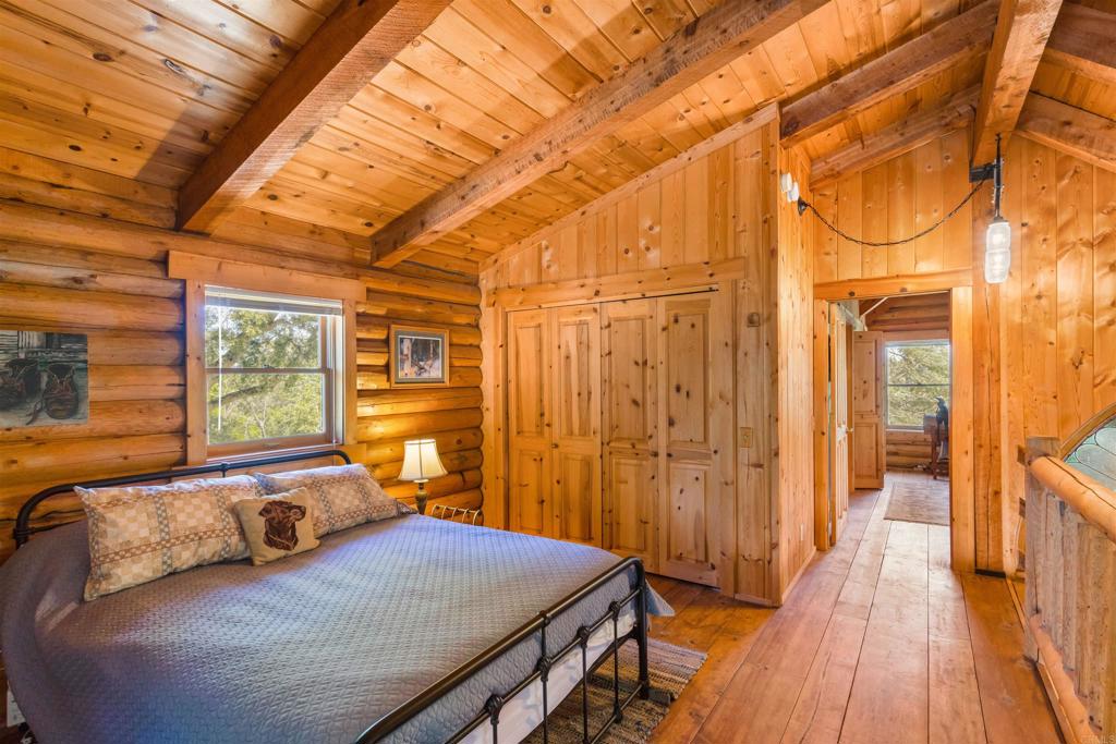 33480 Bailey Meadow Road Palomar Mountain, CA 92060 - Photo 28 of 51 a bedroom with a bed and wooden floor