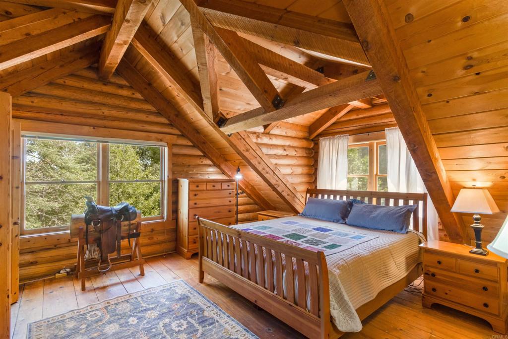 33480 Bailey Meadow Road Palomar Mountain, CA 92060 - Photo 29 of 51 a bedroom with a bed and wooden floor