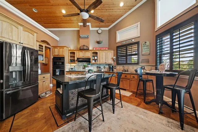 a kitchen with stainless steel appliances cabinets and window