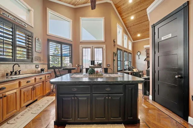 a spacious bedroom with a bed and a chandelier