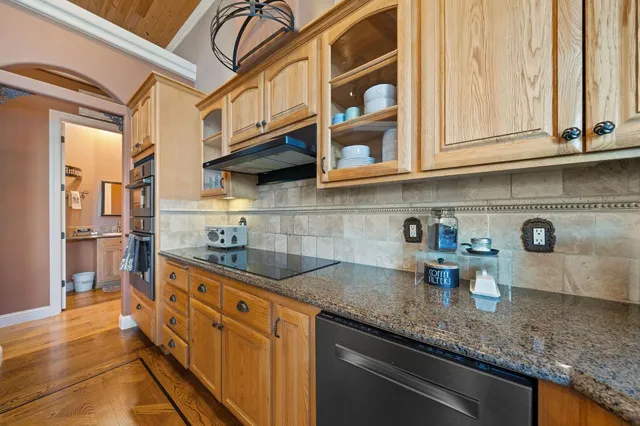 a spacious bedroom with a bed and a chandelier