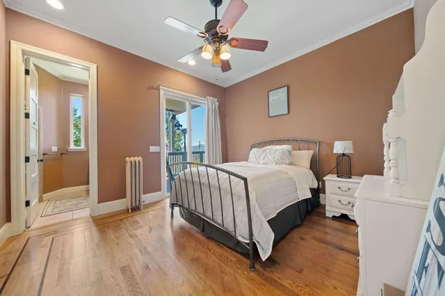 a spacious bedroom with a bed a table and a chandelier