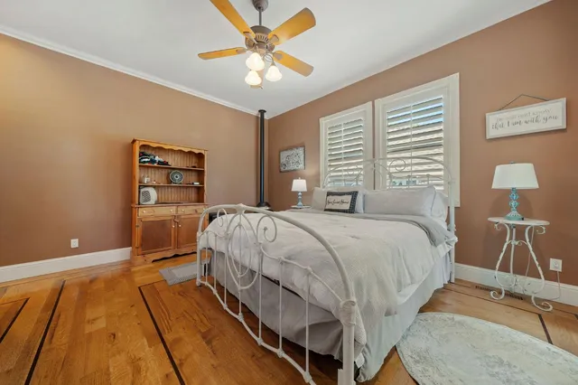a white bath tub sitting in a spacious bathroom next to a window