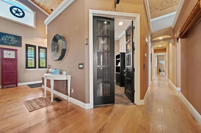 a view of a patio with table and chairs next to a yard