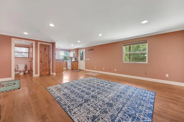 a living room with furniture a rug and a window