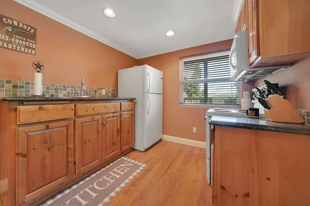 a front view of house with swimming pool and yard