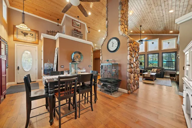 a living room with fireplace furniture and a wooden floor