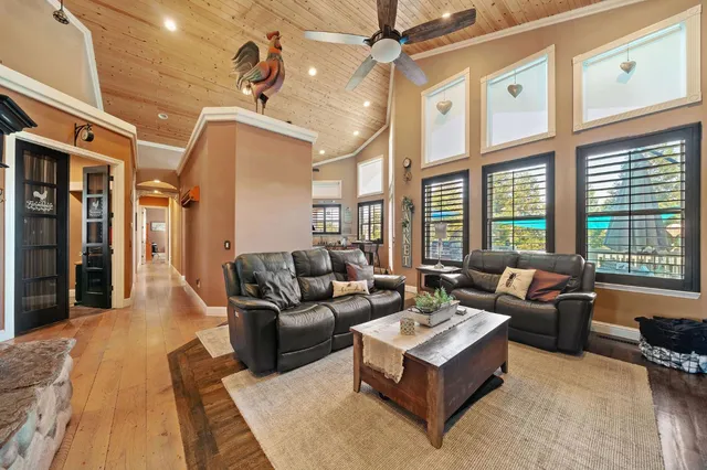 a kitchen with stainless steel appliances kitchen island granite countertop a table chairs and a refrigerator