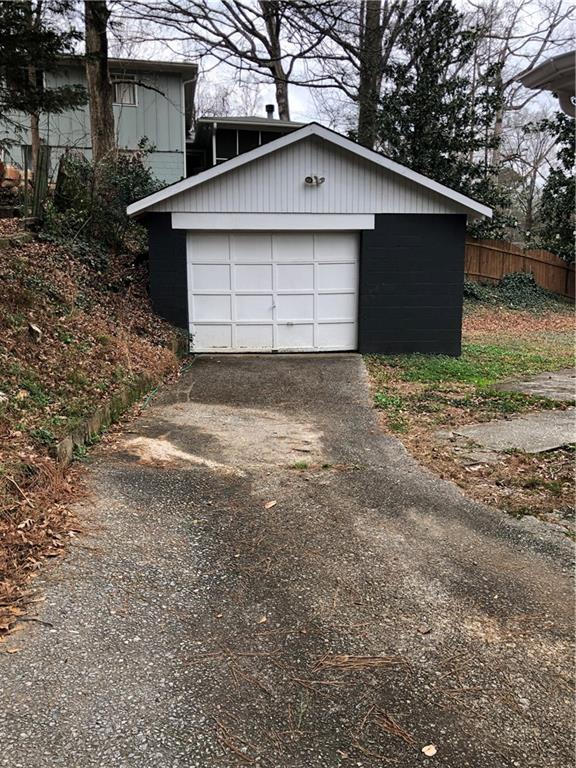 1048 Mantissa Street Northwest Atlanta, GA 30318 - Photo 12 of 12 a front view of a house with a yard and garage