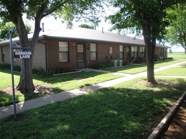 a view of a house with backyard porch and tree