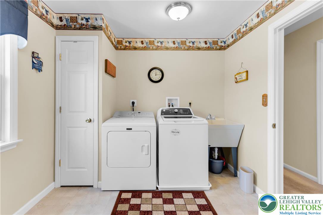 4059 Old Sentry Road Allentown, PA 18104 - Photo 21 of 39 Functional utility room with washer, dryer, and an integrated laundry sink.