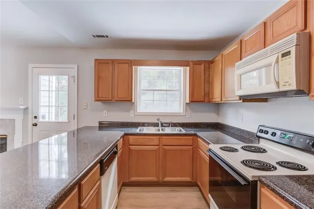 a view of a room with wooden floor and chandelier