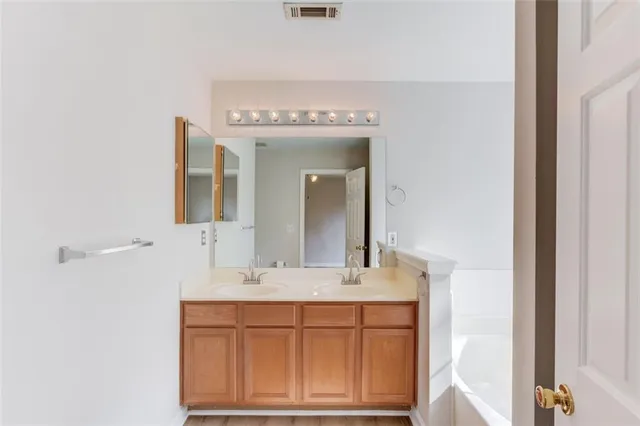 an empty room with window and a ceiling fan
