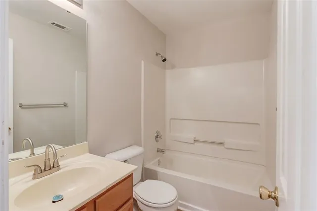 a view of washer and dryer with bathroom in the background