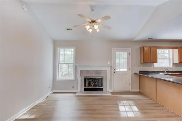 a large kitchen with cabinets wooden floor and stainless steel appliances