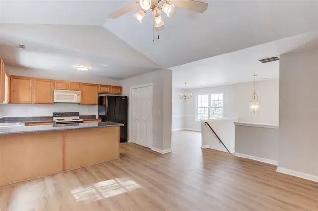 a kitchen that has a sink cabinets counter space and stainless steel appliances