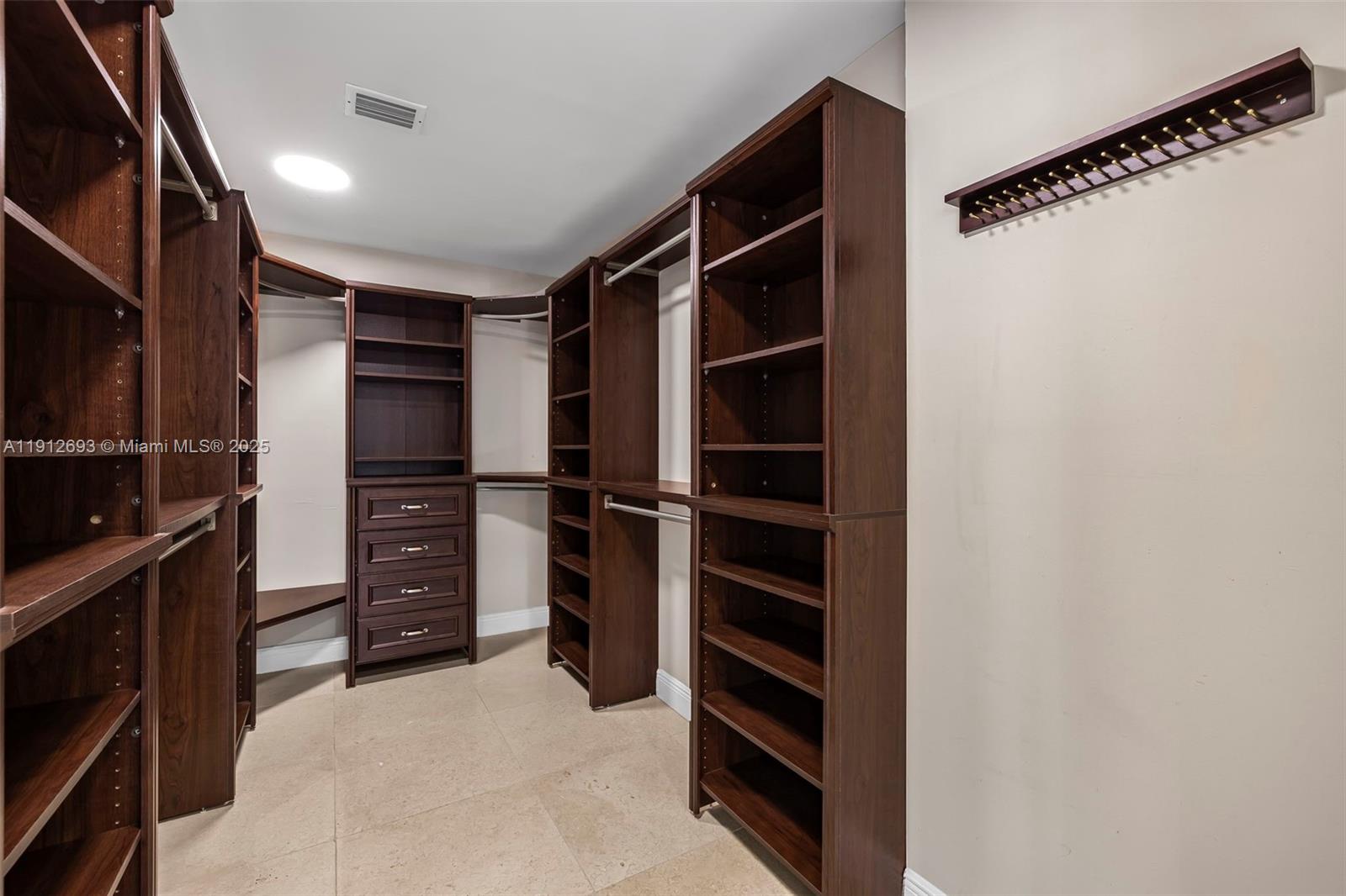 633 Solar Isle Drive Fort Lauderdale, FL 33301 - Photo 12 of 57 a view of walk in closet with clothes and shoes