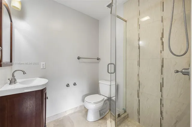 a bathroom with a toilet a sink and shower