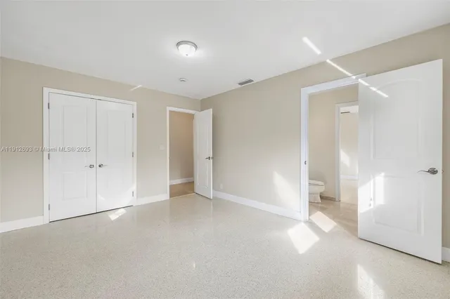 a front view of a house with a garden and trees