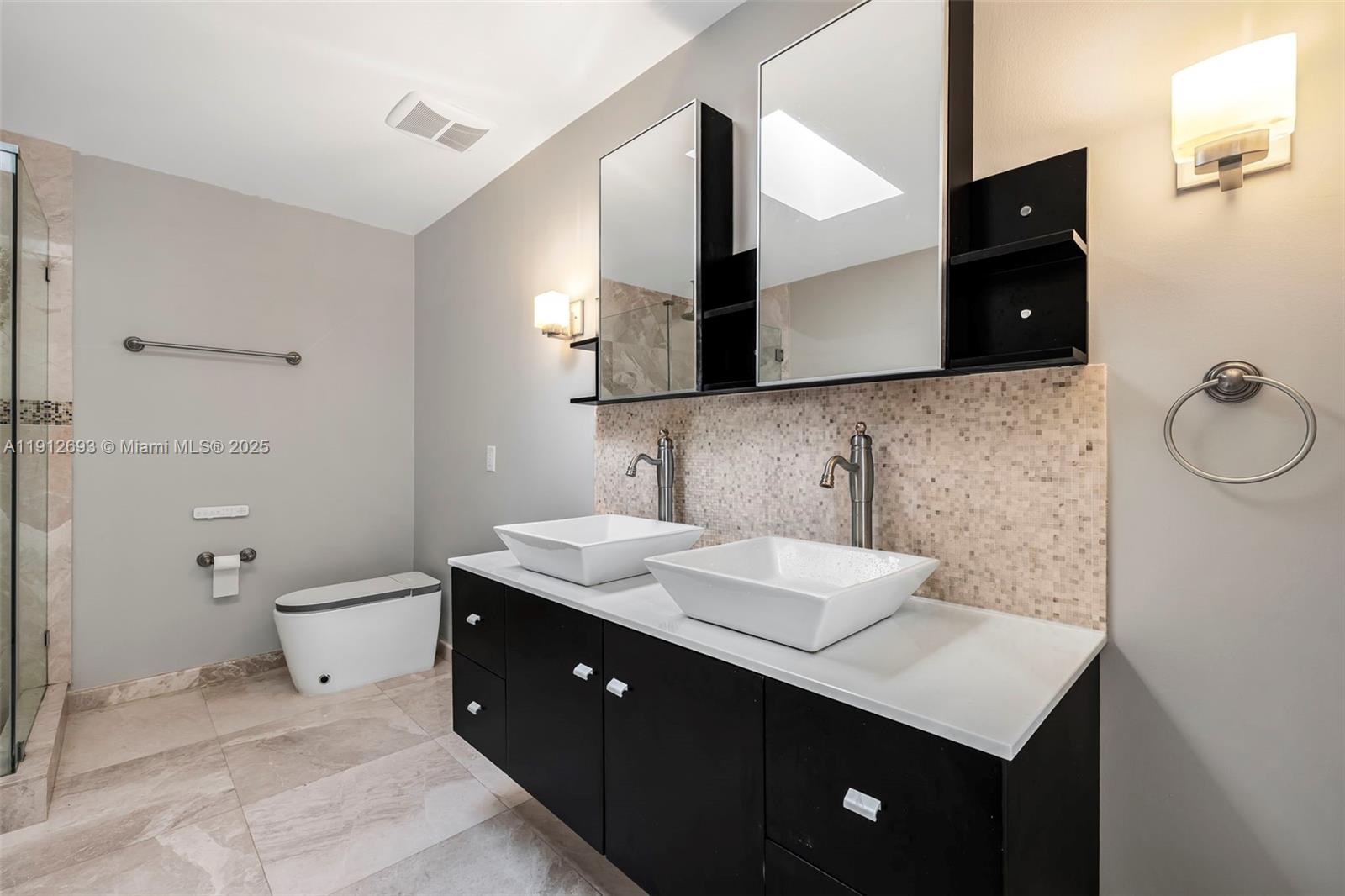 633 Solar Isle Drive Fort Lauderdale, FL 33301 - Photo 24 of 57 a bathroom with a double vanity sink and mirror
