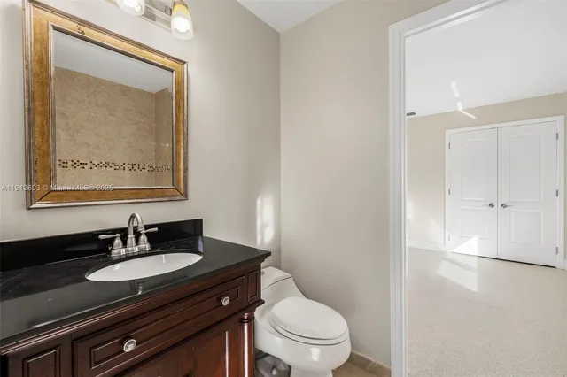 a spacious bathroom with a double vanity sink toilet mirror and bathtub