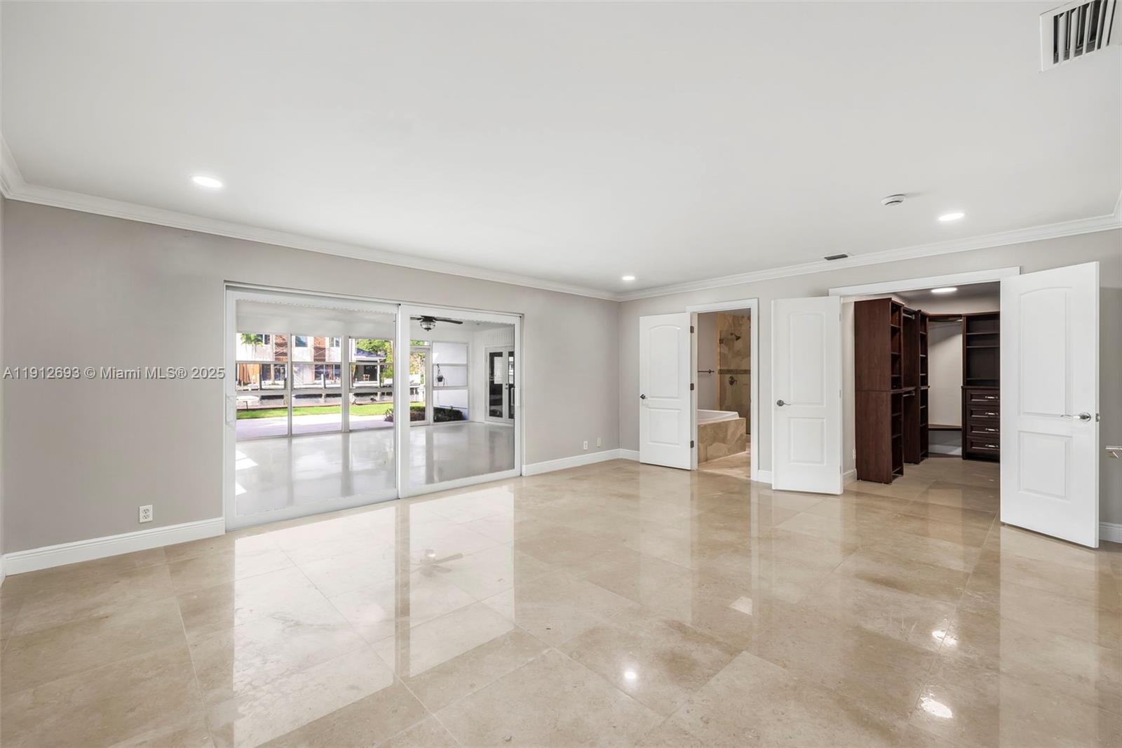 633 Solar Isle Drive Fort Lauderdale, FL 33301 - Photo 31 of 57 a view of a hallway with wooden floor and a living room