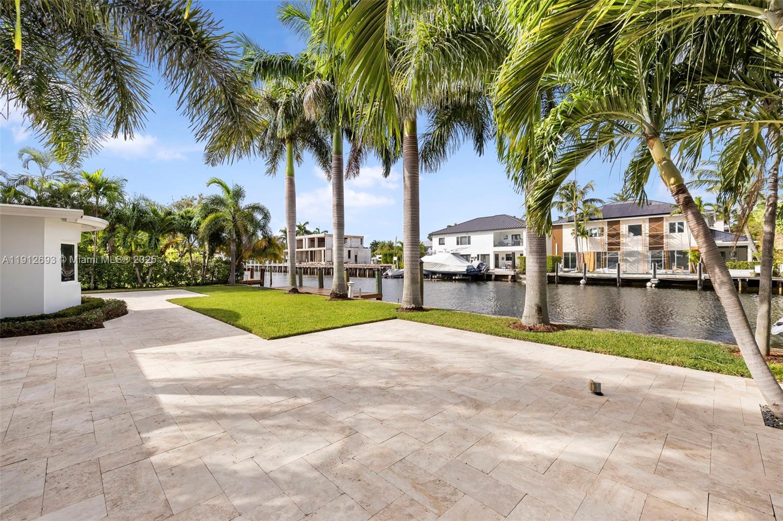 633 Solar Isle Drive Fort Lauderdale, FL 33301 - Photo 32 of 57 a view of swimming pool with palm trees