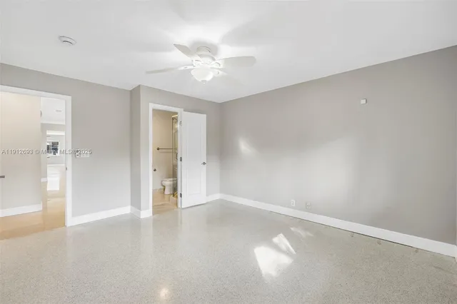 a view of a big room with closet and windows