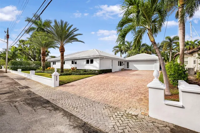 a house with palm tree in front of it