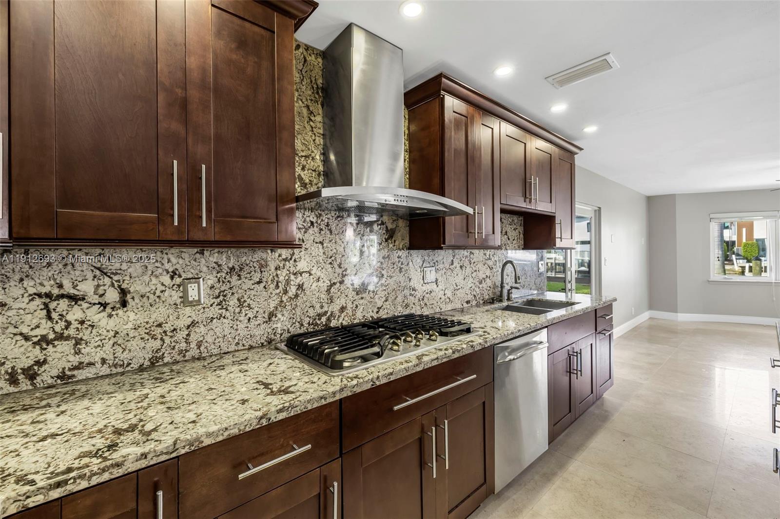 633 Solar Isle Drive Fort Lauderdale, FL 33301 - Photo 42 of 57 a kitchen with stainless steel appliances granite countertop a sink stove and cabinets