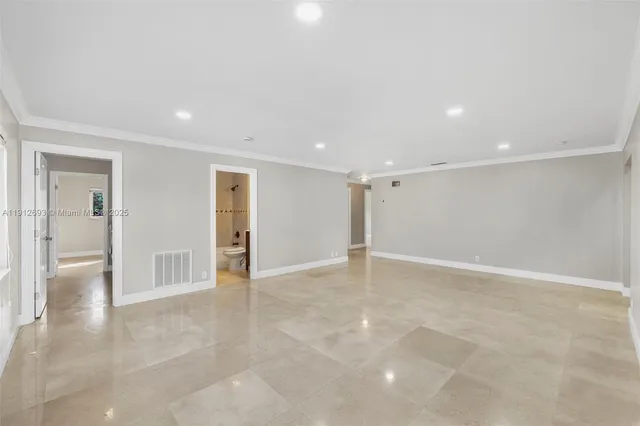 a large kitchen with stainless steel appliances wooden cabinets and a stove top oven