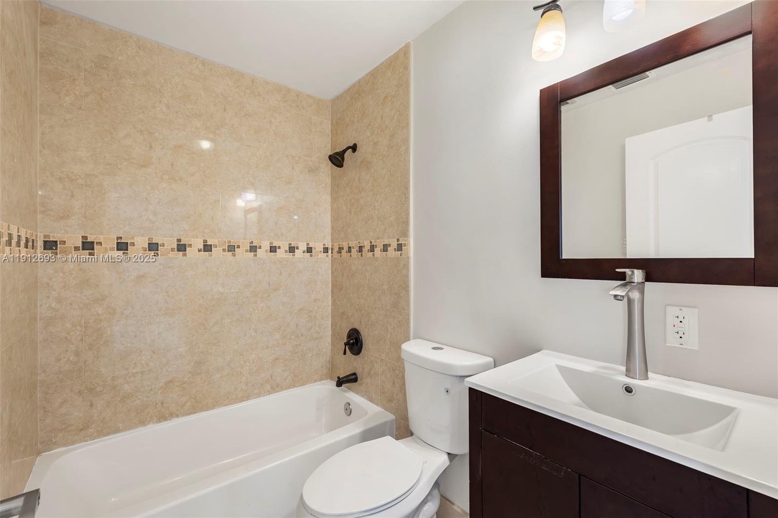 633 Solar Isle Drive Fort Lauderdale, FL 33301 - Photo 44 of 57 a bathroom with a toilet a sink a mirror and bathtub
