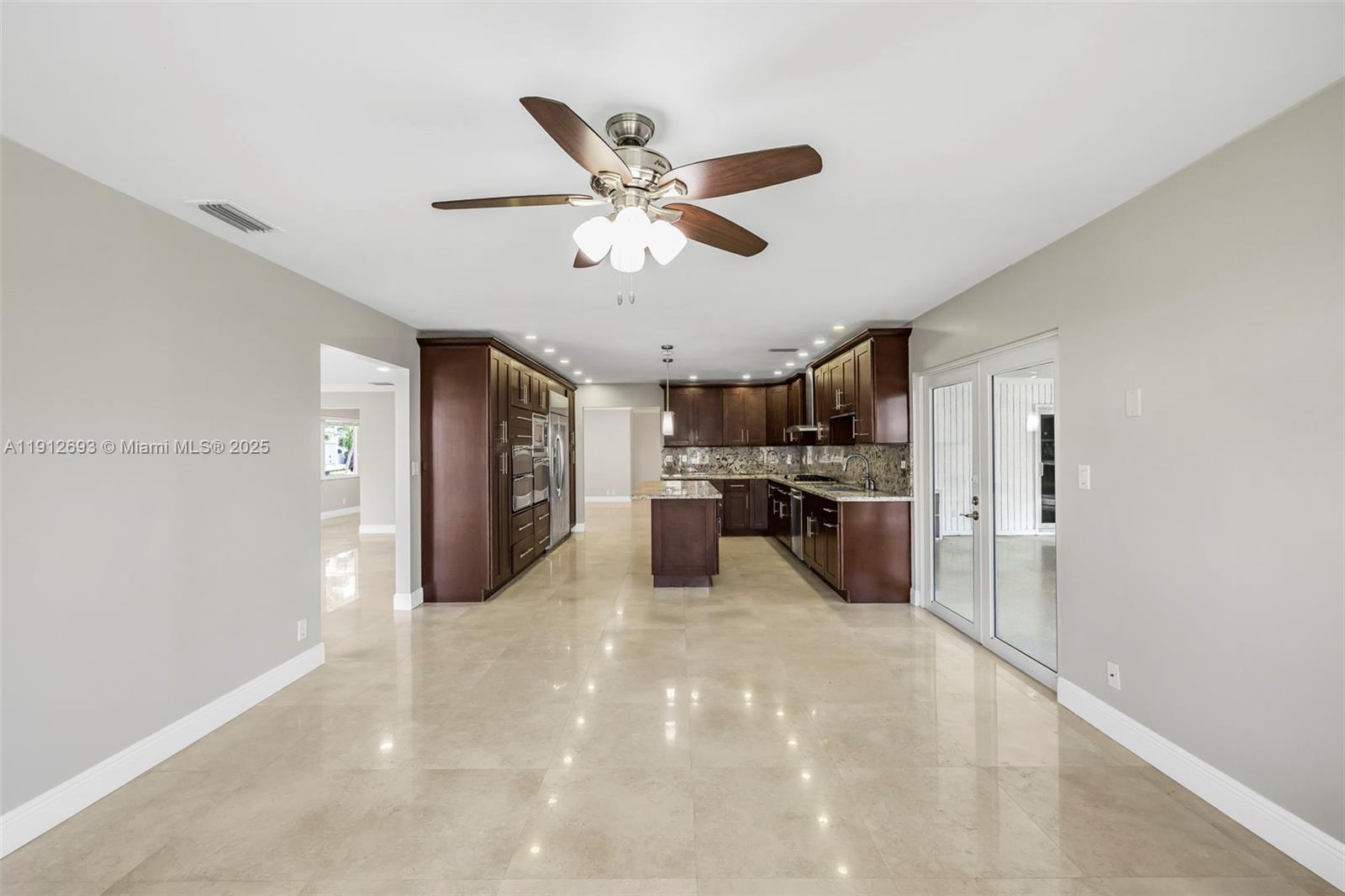 633 Solar Isle Drive Fort Lauderdale, FL 33301 - Photo 49 of 57 a kitchen with a refrigerator and a sink