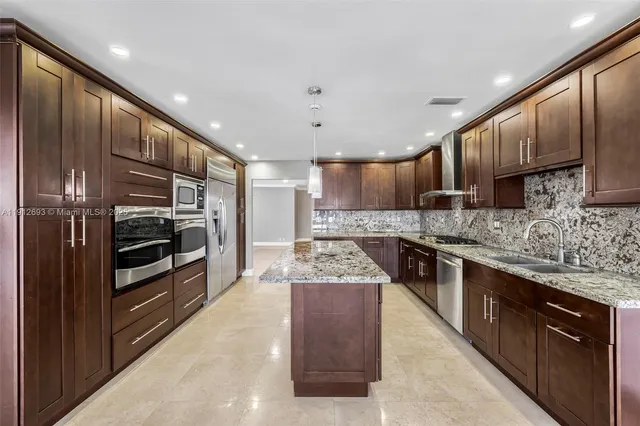 an aerial view of a city with lots of residential buildings ocean and mountain view in back