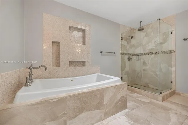 a spacious bathroom with a bathtub and shower