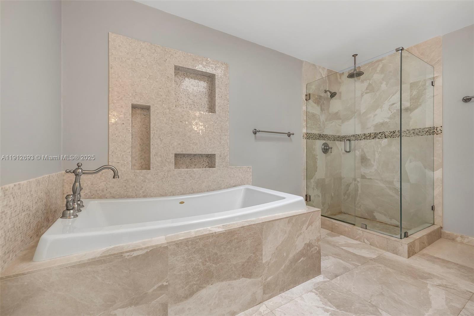 633 Solar Isle Drive Fort Lauderdale, FL 33301 - Photo 7 of 57 a spacious bathroom with a bathtub and shower