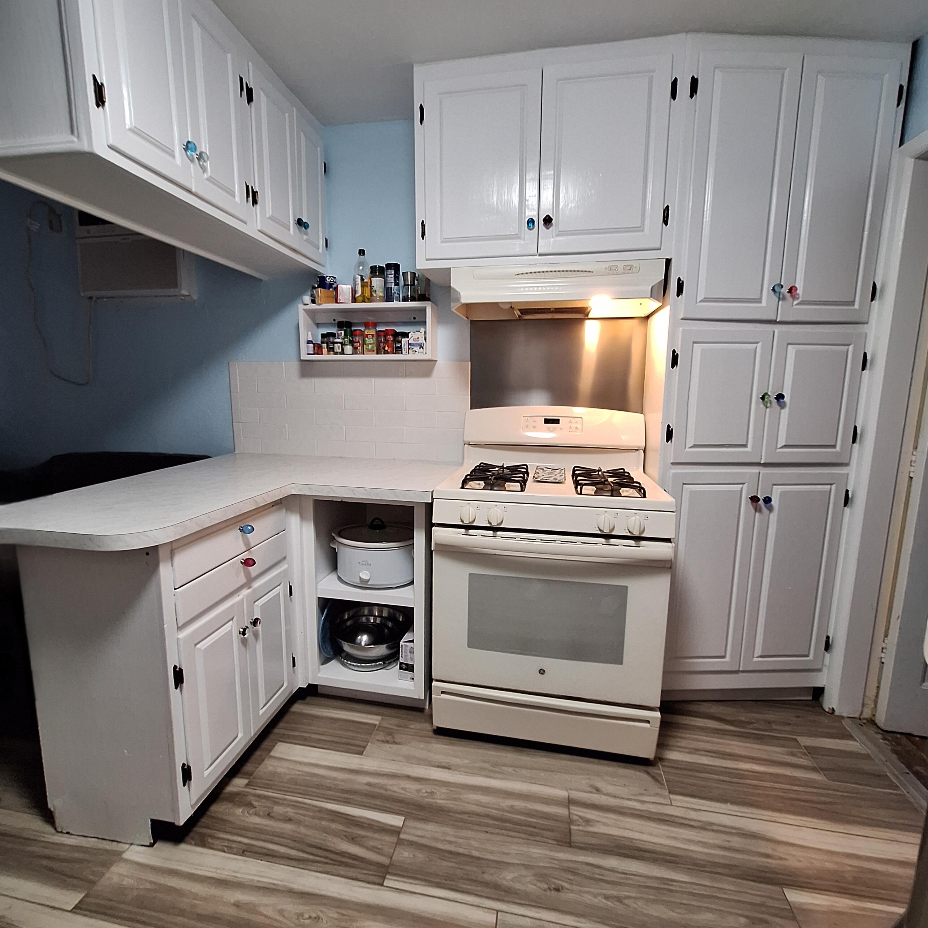 27 Pompano Avenue Key Largo, FL 33037 - Photo 11 of 25 a kitchen with white cabinets and white appliances