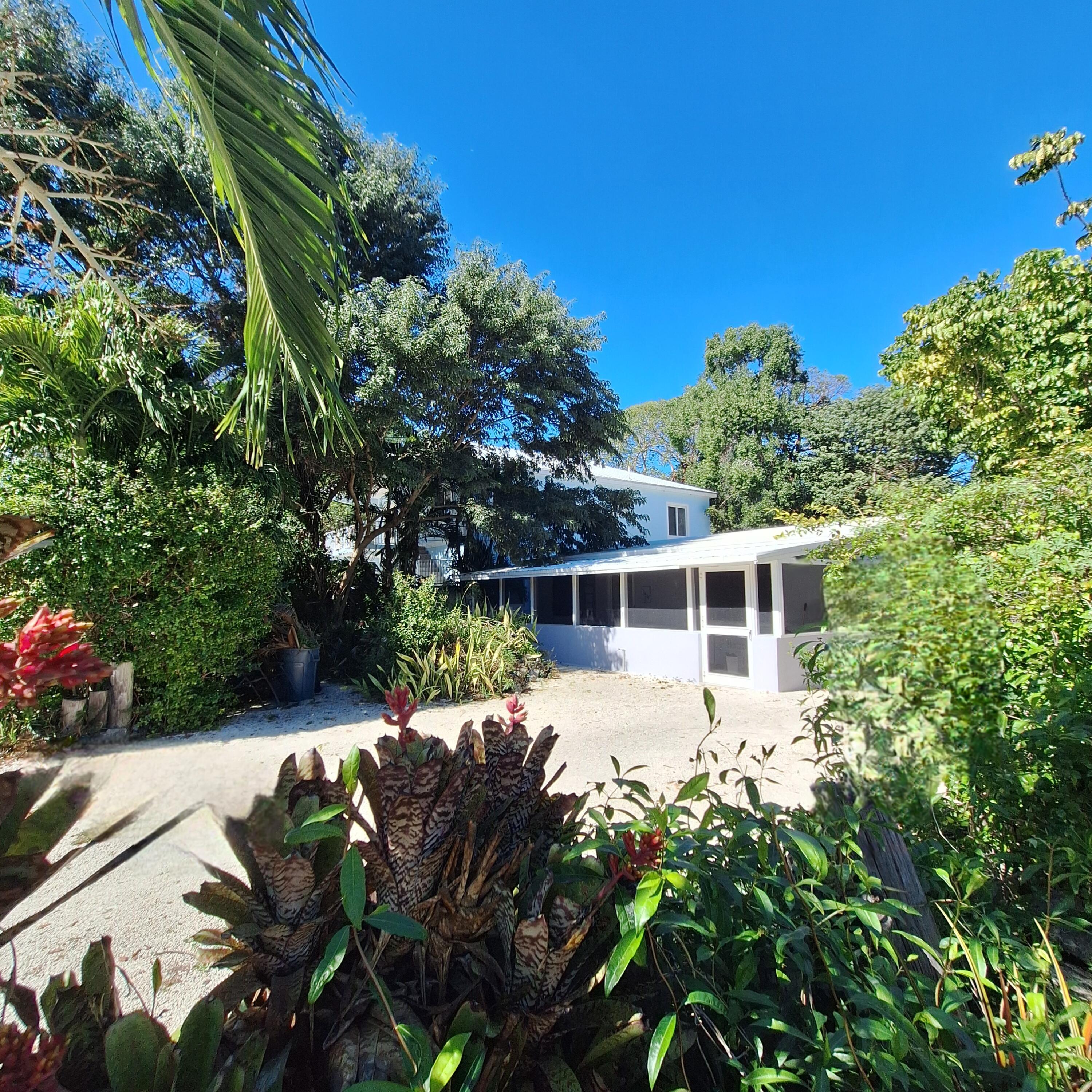 27 Pompano Avenue Key Largo, FL 33037 - Photo 2 of 25 a front view of a house with a yard
