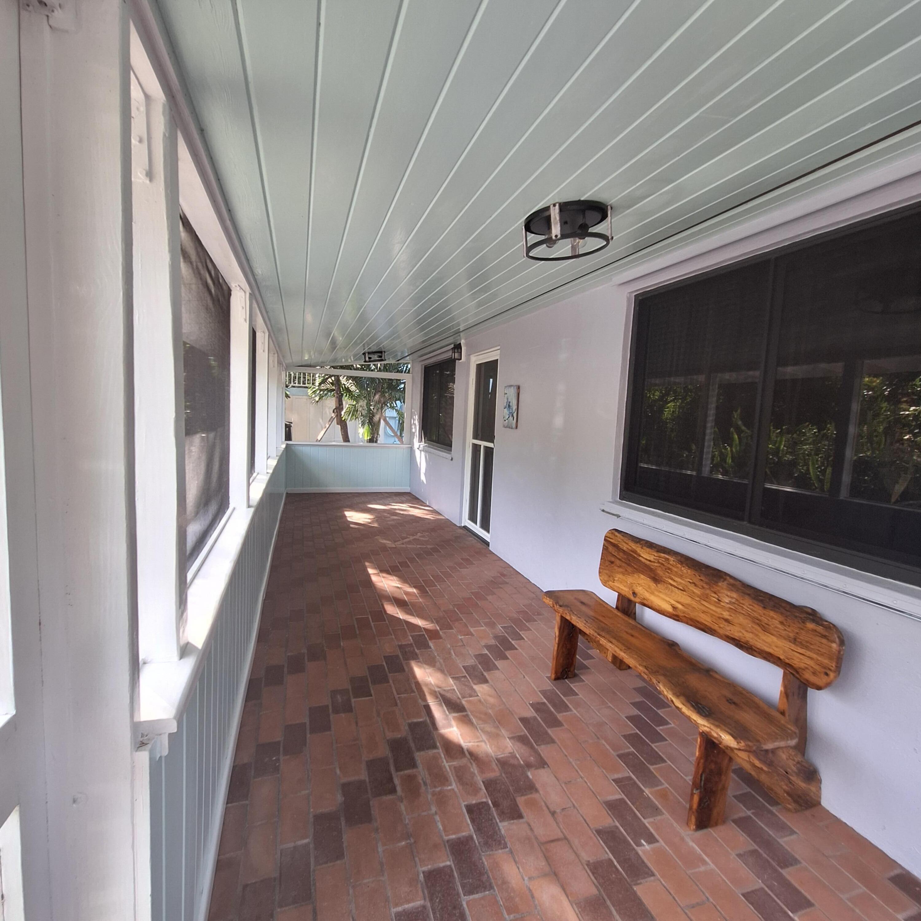 27 Pompano Avenue Key Largo, FL 33037 - Photo 5 of 25 a hallway with a bench in balcony