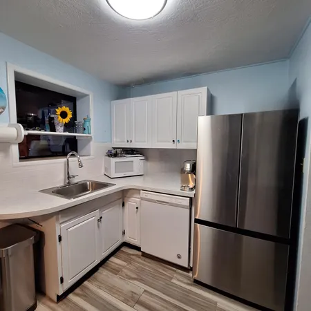 a kitchen with stainless steel appliances a refrigerator sink and cabinets